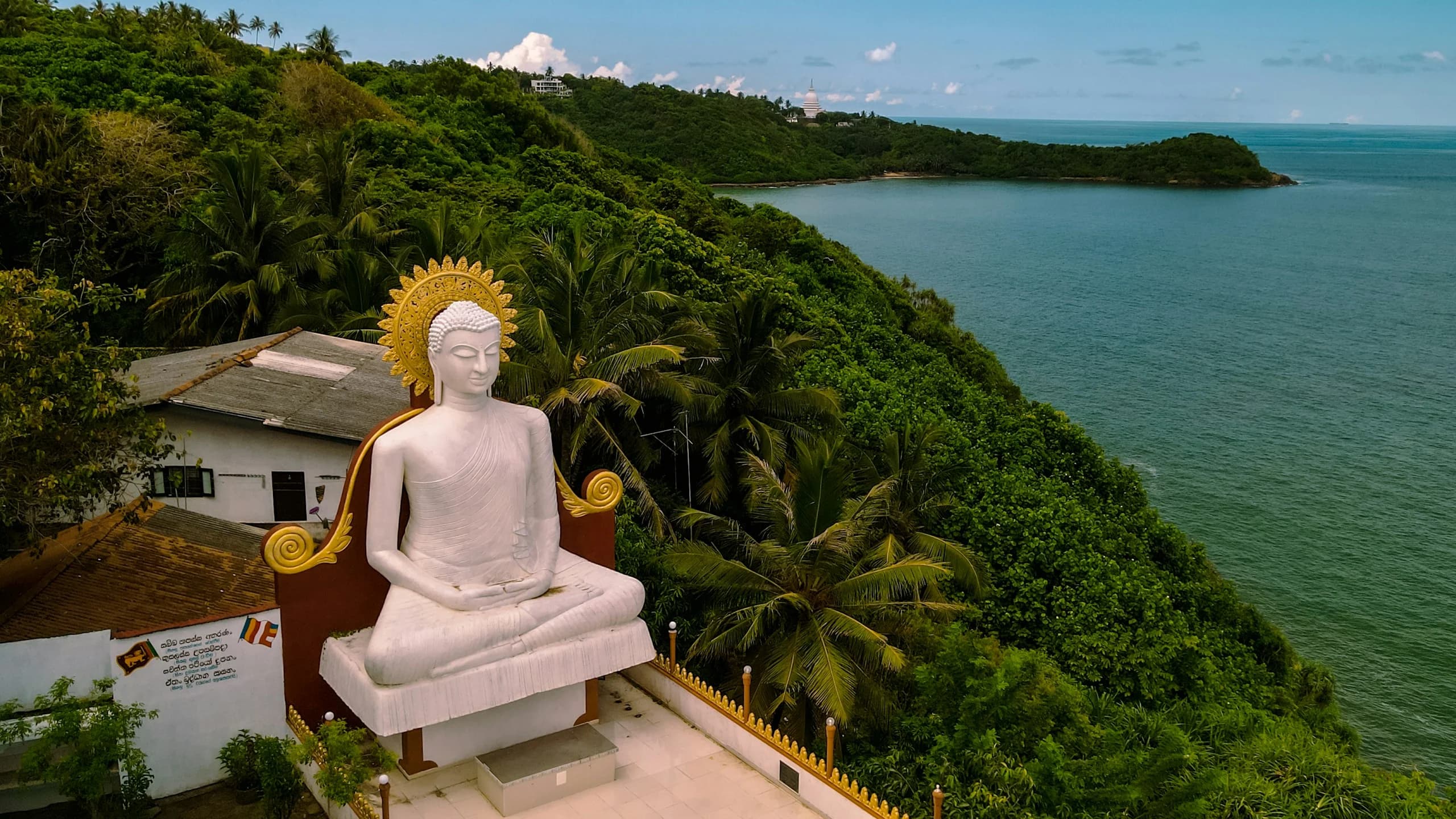 A white Buddha statue overlooking the Sri Lankan coastline